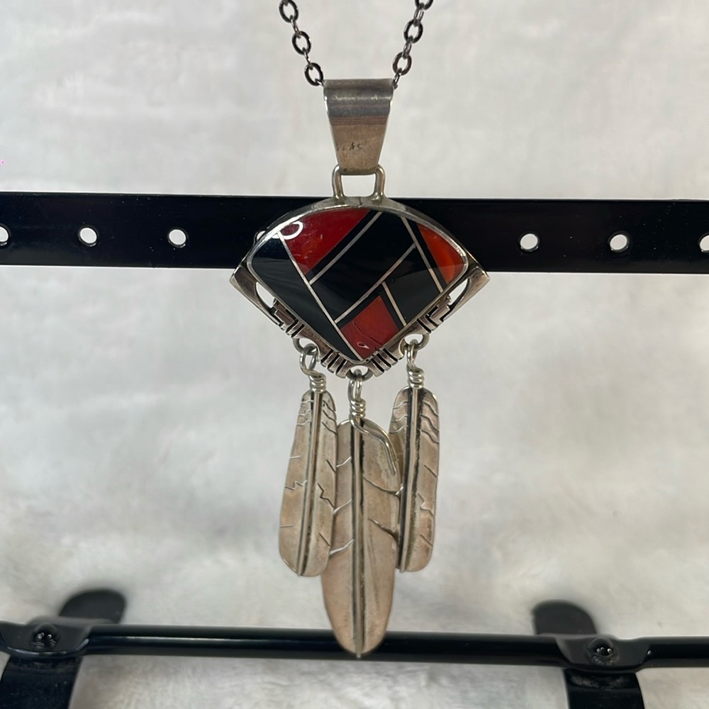 Navajo red coral and onyx pendant. Signed: Gilbert Nelson. 3 1/3” long.